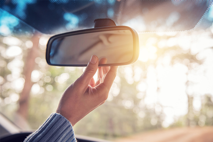 hand on rearview mirror