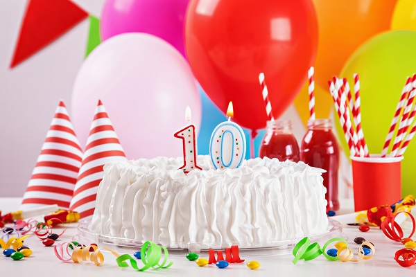 EMC photo of balloons and a birthday cake with number 10 candles on top