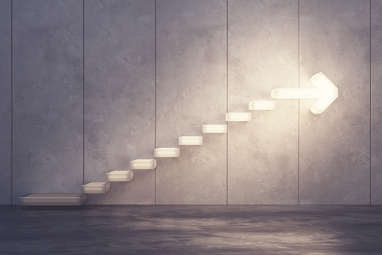 Lit up staircase with arrow at the top