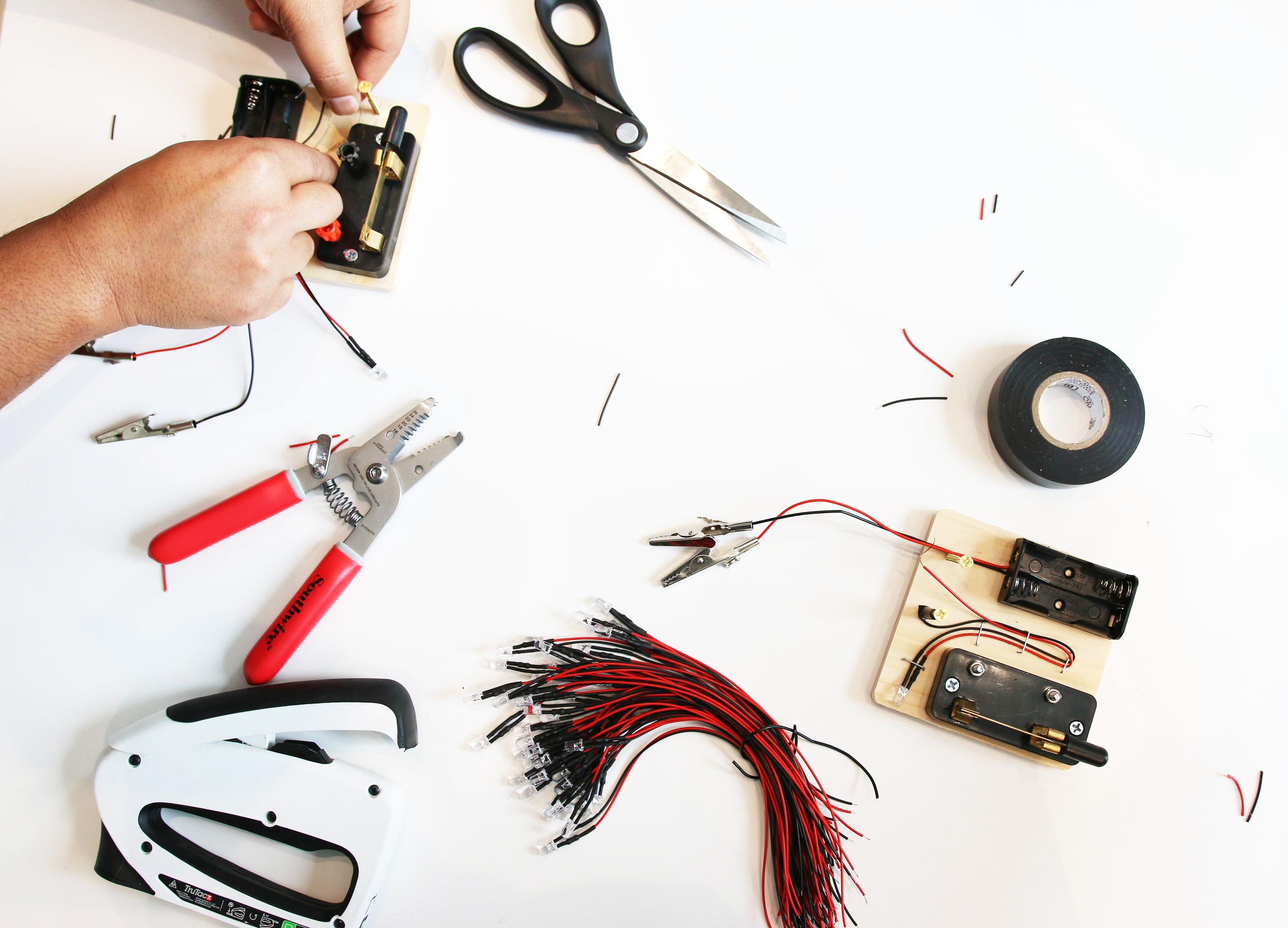 Hand working on electrical circuits and LED lights