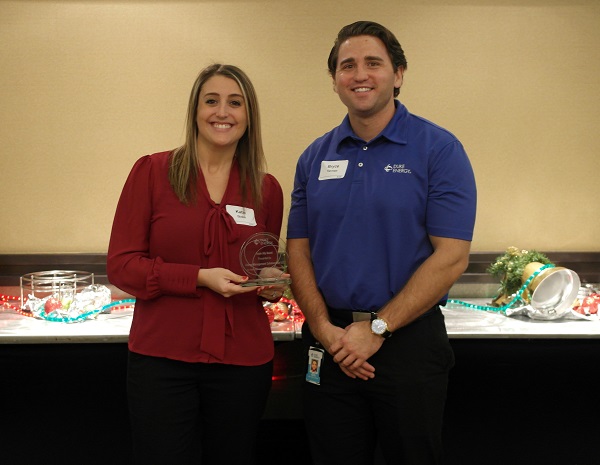 EMC incentives manager and Duke energy representatives holding award