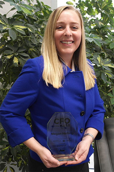 EMC photo of CFO, Megan Helling with award